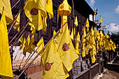 Chiang Mai - The Wat Phan Tao temple, small chedi shaped structures decorated with colorfull flags on the southern side wall of the Wihan 